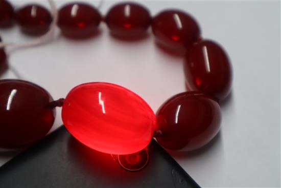 A single strand graduated simulated cherry amber necklace, gross weight 95 grams,